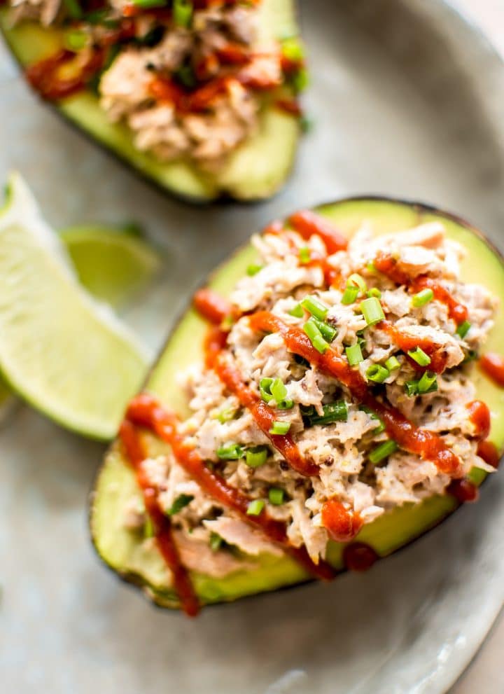This spicy tuna stuffed avocado is healthy, fast, and delicious. This low-carb keto recipe is ready in only 10 minutes! It's super flavorful with sriracha, lime, mayo, mustard, and chives! An easy lunch idea. 