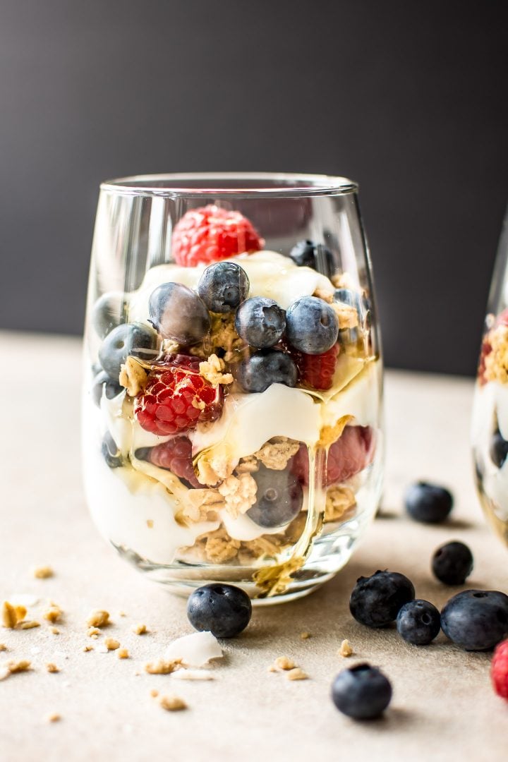 blueberry and raspberry yogurt parfait in a clear glass