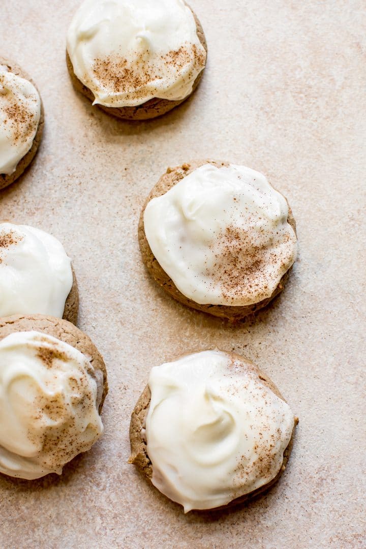 several carrot cake cookies with cream cheese frosting and cinnamon