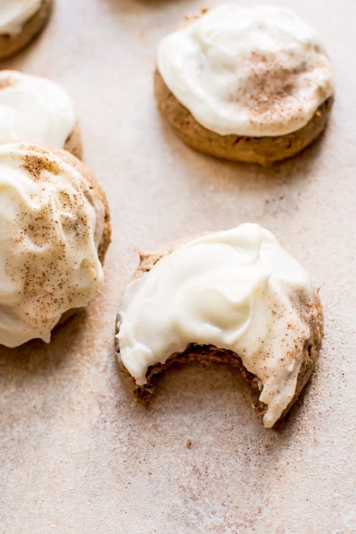 close-up of carrot cake cookie with cream cheese frosting with a bite taken