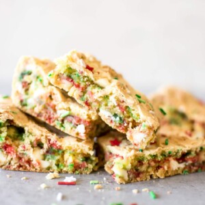 Easy Christmas cake batter blondies make holiday baking simpler! A perfect sweet treat that the whole family will love. You can bring these bars to Christmas parties or cookie exchanges, and kids will love them.