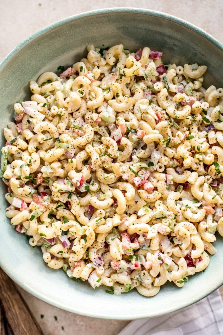 close-up of creamy macaroni salad in a teal bowl