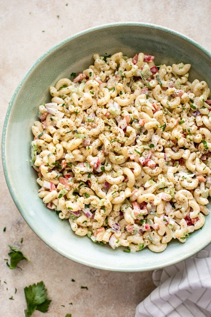 creamy vegetarian macaroni salad in a teal bowl