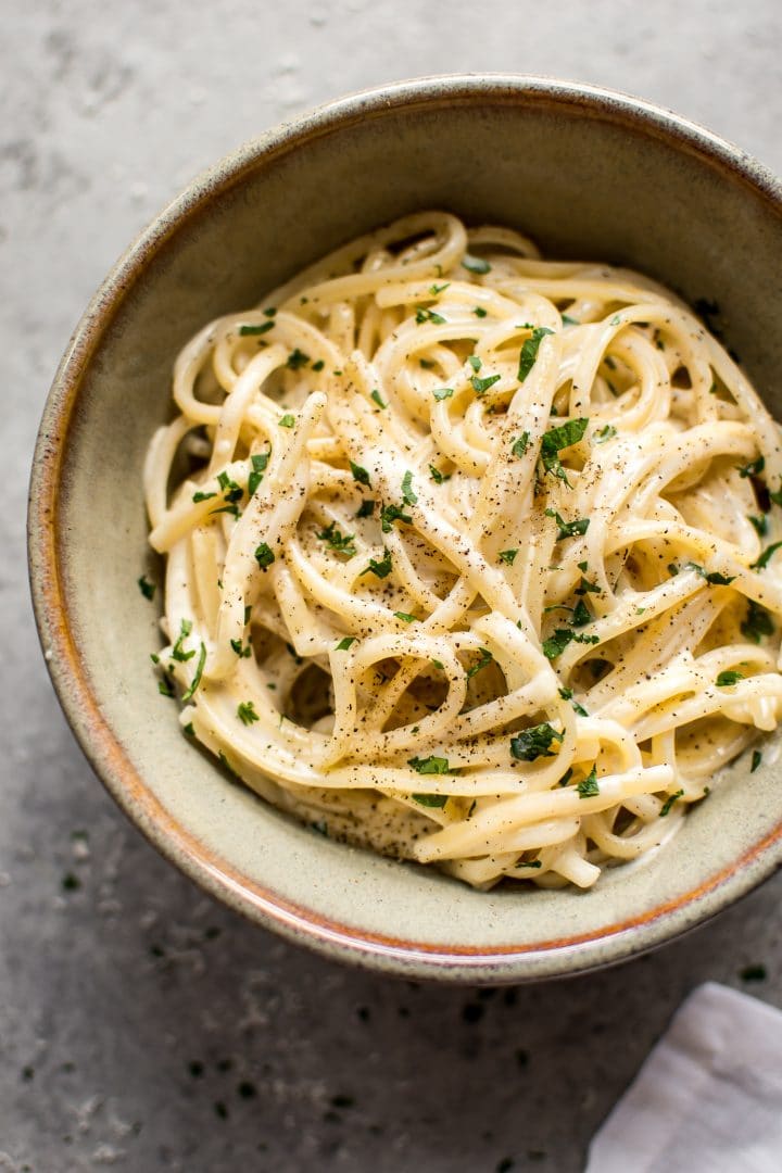 creamy garlic pasta in earthenware bowl