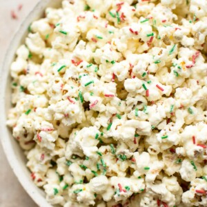 This white chocolate Christmas popcorn recipe is easy and festive. Perfect for Christmas parties! You can easily portion it out into bags for kids' snacks or fun and simple homemade edible Christmas gifts.