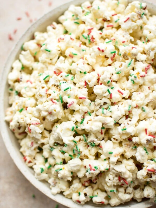 This white chocolate Christmas popcorn recipe is easy and festive. Perfect for Christmas parties! You can easily portion it out into bags for kids' snacks or fun and simple homemade edible Christmas gifts.