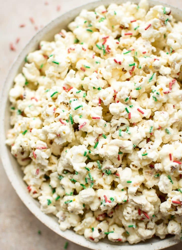 This white chocolate Christmas popcorn recipe is easy and festive. Perfect for Christmas parties! You can easily portion it out into bags for kids' snacks or fun and simple homemade edible Christmas gifts.