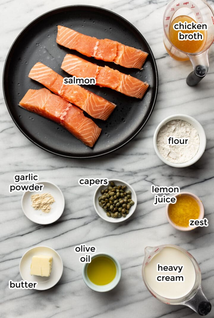 ingredients for salmon piccata on a marble surface