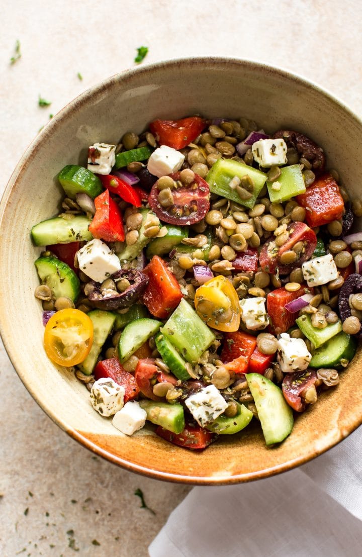 mediterranean lentil salad with feta and vegetables in an earthenware bowl