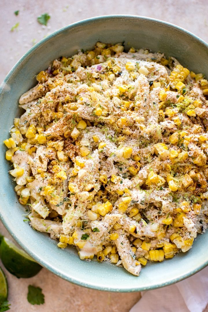 close-up of Mexican street corn pasta salad in a teal bowl