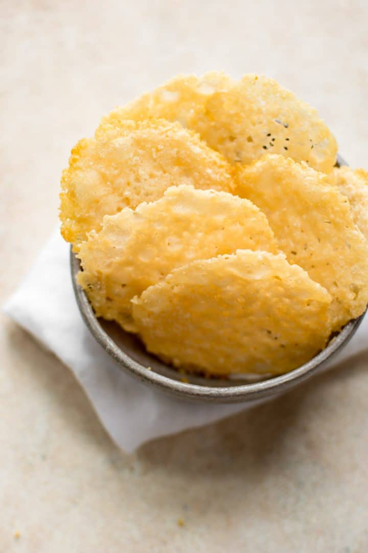 keto parmesan cheese crisps in a grey snack bowl with a white cloth napkin