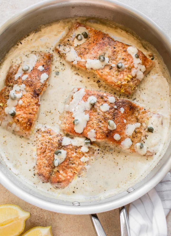 This creamy lemon salmon piccata is the perfect easy weeknight dinner. You can either use white wine or chicken broth in the lemon butter garlic caper sauce. Perfect served with pasta!