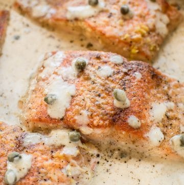 This creamy lemon salmon piccata is the perfect easy weeknight dinner. You can either use white wine or chicken broth in the lemon butter garlic caper sauce. Perfect served with pasta!