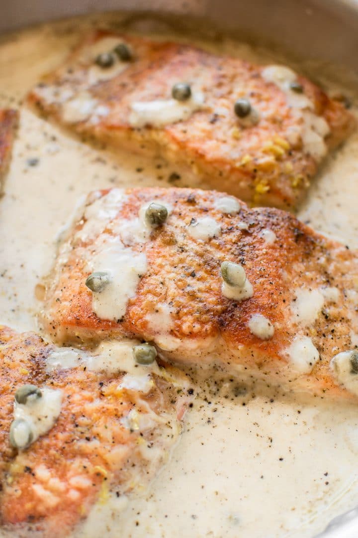 close-up of a piece of salmon smothered with a creamy caper piccata sauce