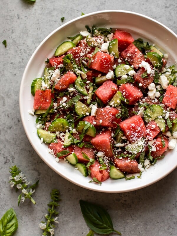 This watermelon feta salad has fresh basil, cucumber, mint, and an easy and delicious, light, and tangy balsamic vinaigrette dressing. It's a perfect side salad or appetizer for summer dinner parties!