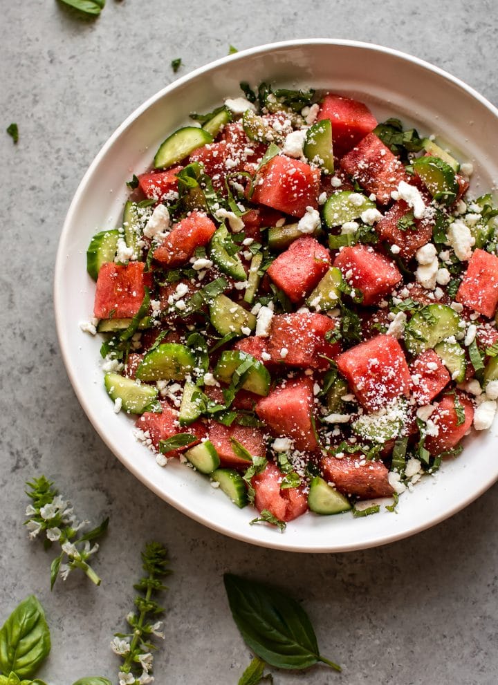 This watermelon feta salad has fresh basil, cucumber, mint, and an easy and delicious, light, and tangy balsamic vinaigrette dressing. It's a perfect side salad or appetizer for summer dinner parties!