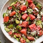 This watermelon feta salad has fresh basil, cucumber, mint, and an easy and delicious, light, and tangy balsamic vinaigrette dressing. It's a perfect side salad or appetizer for summer dinner parties!