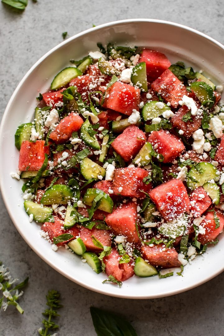 watermelon, cucumber, and feta salad in a white bowl close-up