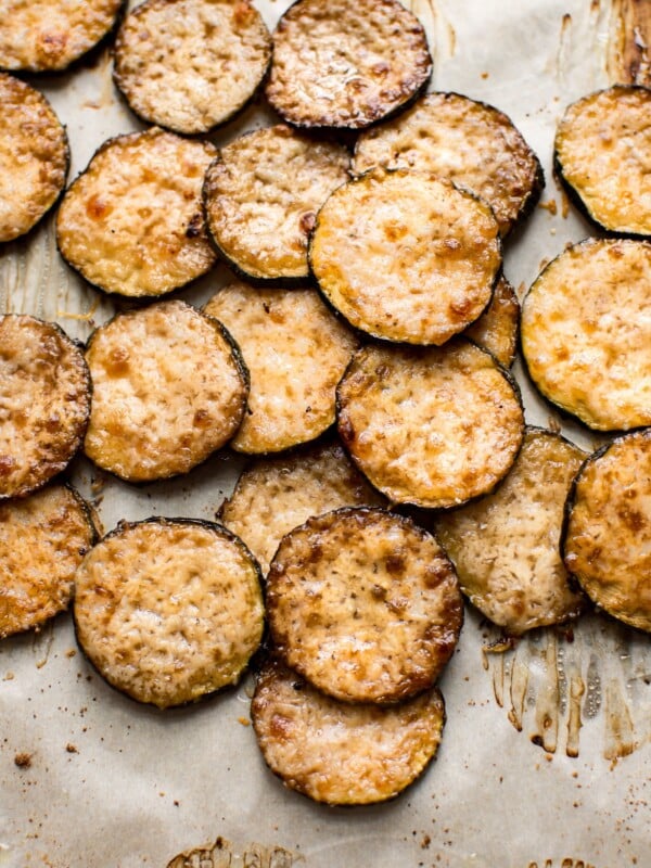 Easy baked parmesan zucchini chips with garlic and balsamic vinegar. A delicious roasted zucchini side dish. These little bites are a delicious low-carb keto snack!