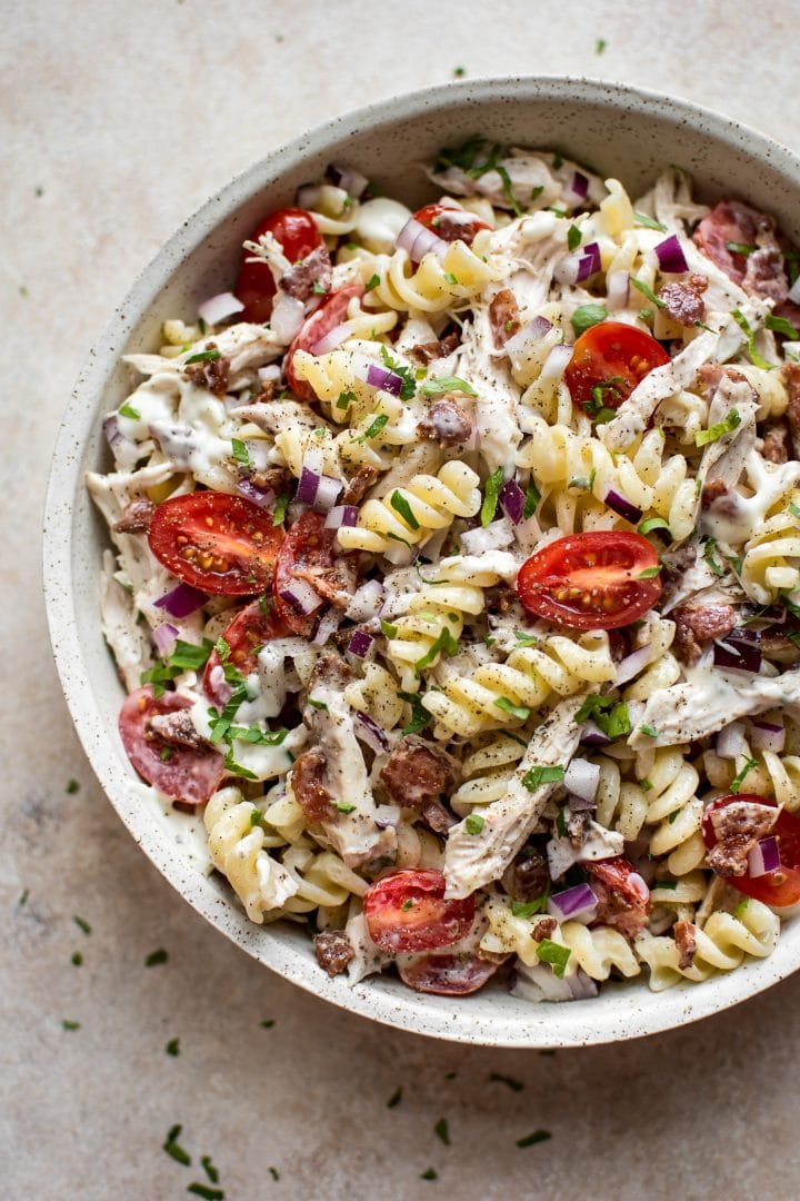 simple chicken bacon ranch pasta salad with little tomatoes in a serving bowl