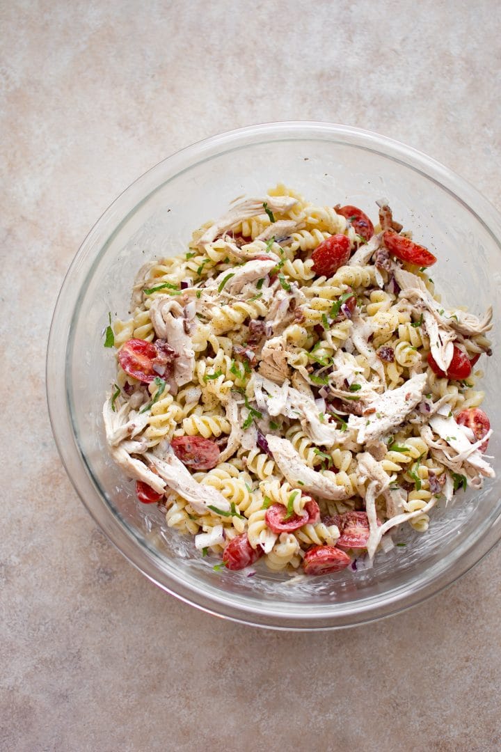 chicken bacon ranch pasta salad in a glass mixing bowl