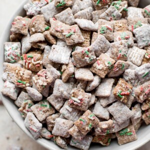 This Christmas puppy chow mix with powdered sugar, gluten-free rice Chex cereal, and plenty of sprinkles is a fun and family-friendly holiday party recipe! You won't be able to resist snacking on it. 