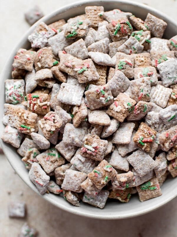 This Christmas puppy chow mix with powdered sugar, gluten-free rice Chex cereal, and plenty of sprinkles is a fun and family-friendly holiday party recipe! You won't be able to resist snacking on it. 