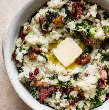 This easy colcannon recipe is a traditional Irish side dish that's a great addition to your St. Patrick's Day table.  This version is with kale (or use cabbage) and bacon! Serve with plenty of butter.