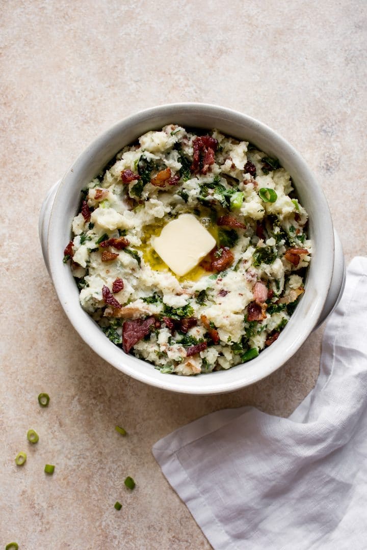 Colcannon Irish mashed potatoes and kale with bacon in a bowl with butter