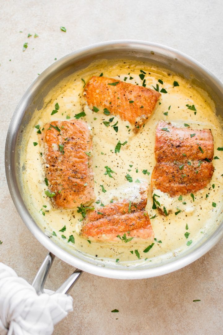 creamy dijon salmon in a metal skillet