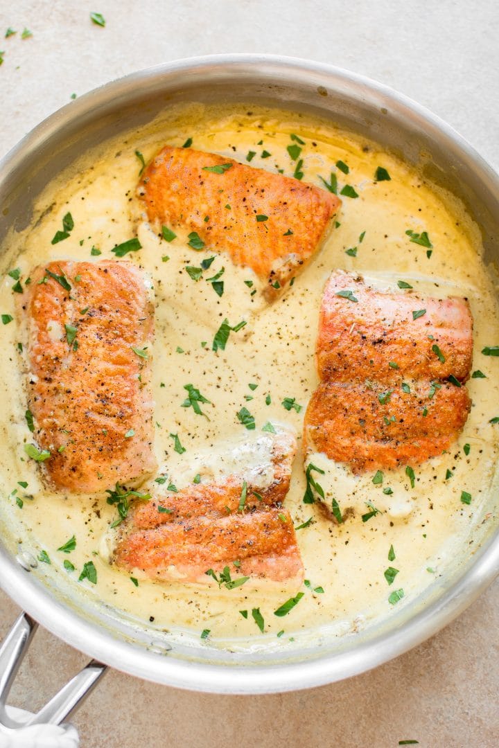 close-up of creamy dijon salmon in metal skillet