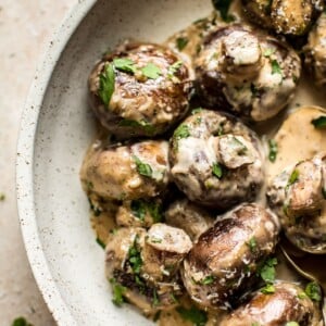 These creamy garlic mushrooms are seared until they're golden brown and then cooked in a mouthwatering cream sauce. A simple low-carb comfort food side dish that's ready in less than 20 minutes!