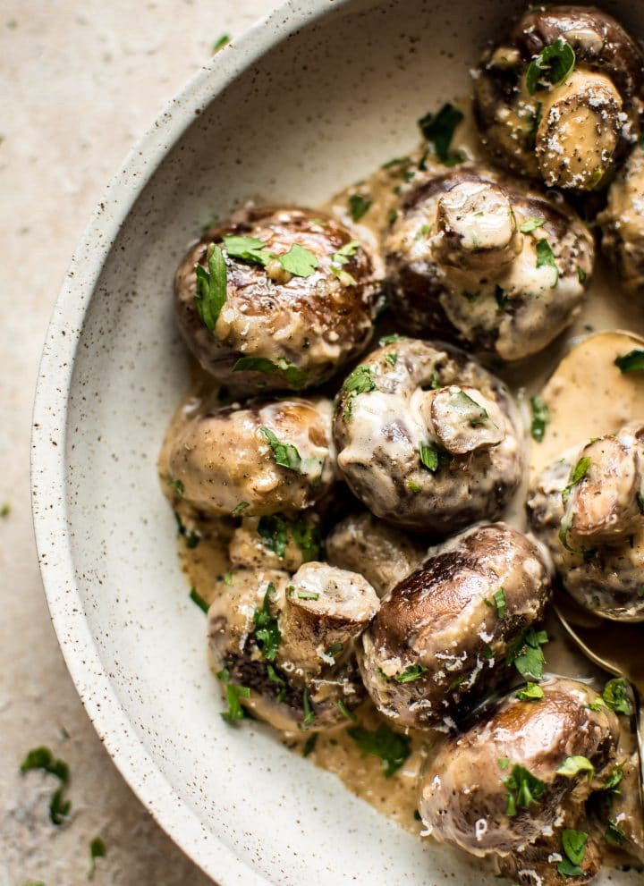 These creamy garlic mushrooms are seared until they're golden brown and then cooked in a mouthwatering cream sauce. A simple low-carb comfort food side dish that's ready in less than 20 minutes!