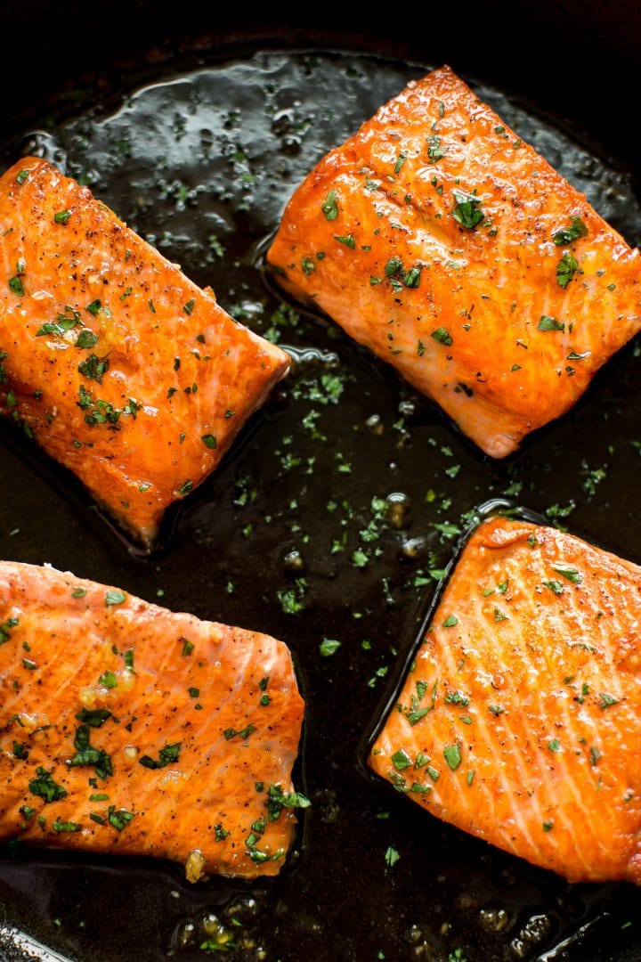 four pieces of easy honey garlic salmon in a skillet