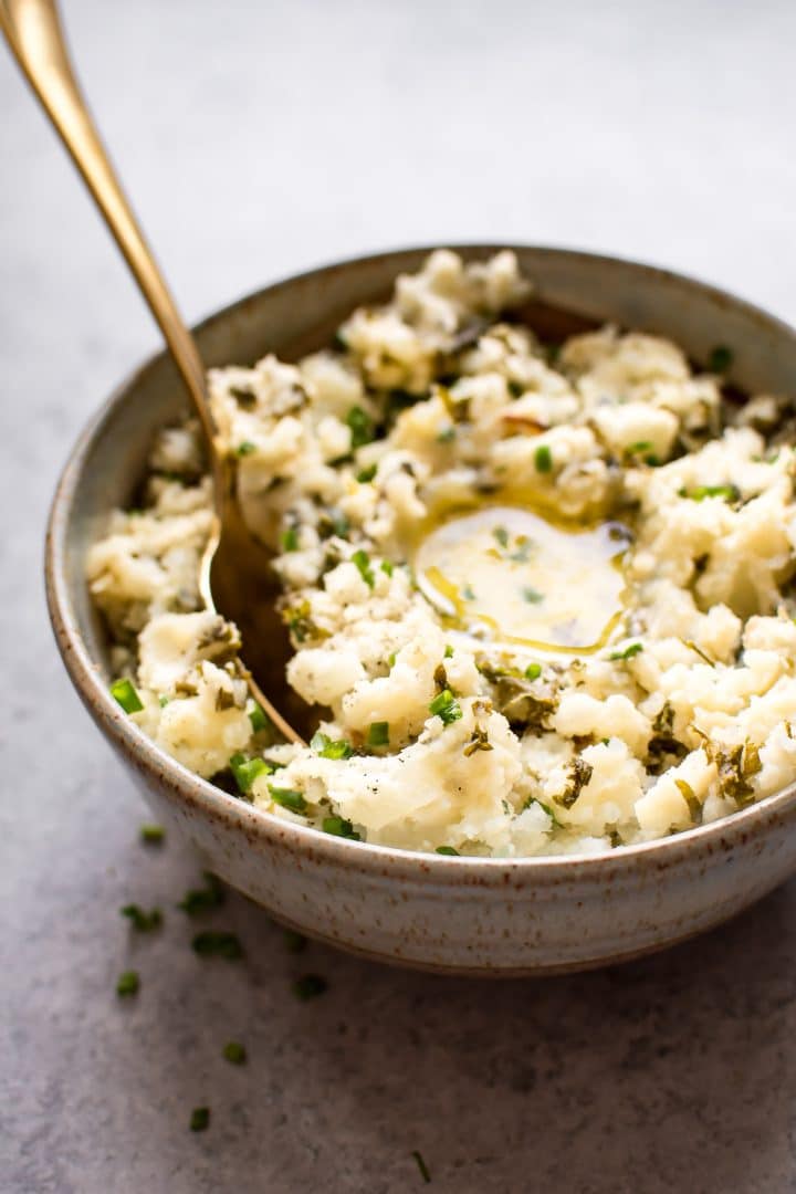 close-up of Colcannon Irish mashed potatoes and kale in a bowl with a spoon