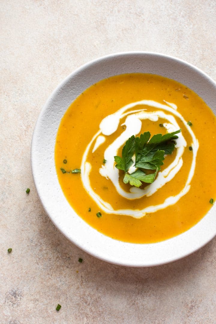 This healthy pumpkin soup recipe is made with canned pumpkin purée. It's fast, easy, and silky from the coconut milk!