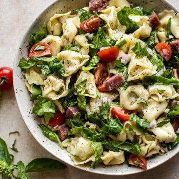 This easy cold spinach tortellini salad has a delicious homemade Italian dressing, salami, basil, and fresh tomatoes. The perfect pasta salad to feed a crowd for potlucks, picnics, or summer BBQs. 