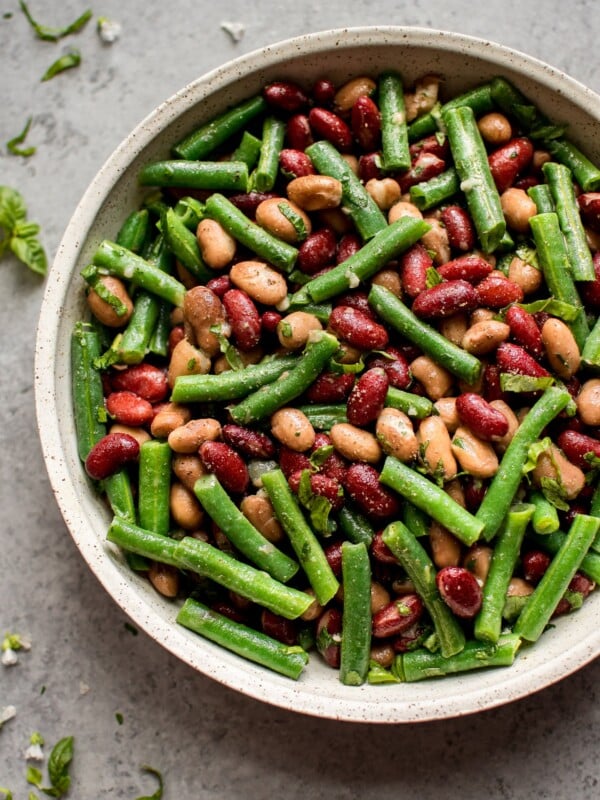 This easy and healthy three bean salad is an updated version of the old fashioned traditional side dish! Fresh green beans, red kidney beans, romano beans (or use chickpeas), and a sweet and tangy vinaigrette make this one delicious salad.