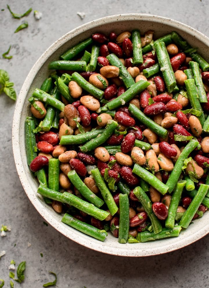 This easy and healthy three bean salad is an updated version of the old fashioned traditional side dish! Fresh green beans, red kidney beans, romano beans (or use chickpeas), and a sweet and tangy vinaigrette make this one delicious salad.