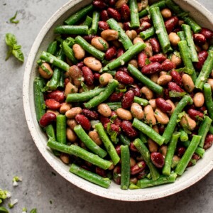 This easy and healthy three bean salad is an updated version of the old fashioned traditional side dish! Fresh green beans, red kidney beans, romano beans (or use chickpeas), and a sweet and tangy vinaigrette make this one delicious salad.
