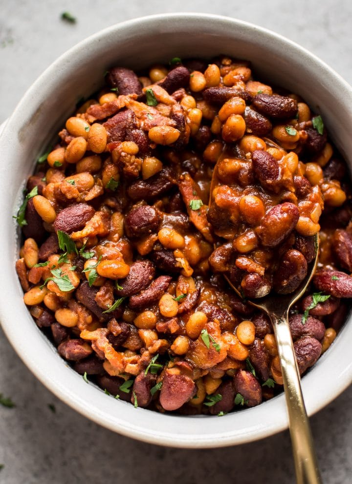 Easy homemade baked beans with bacon - a from scratch recipe that is perfect as a main course, side dish, or cookout/BBQ recipe. 