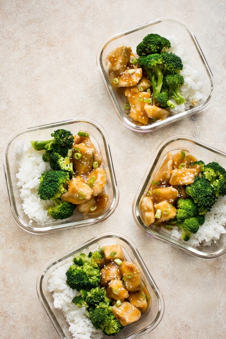 four glass containers with honey ginger meal prep bowls with broccoli and rice
