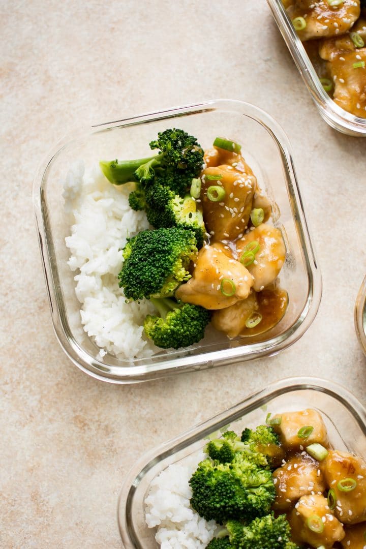 two glass containers with honey ginger meal prep bowls recipe with broccoli and rice