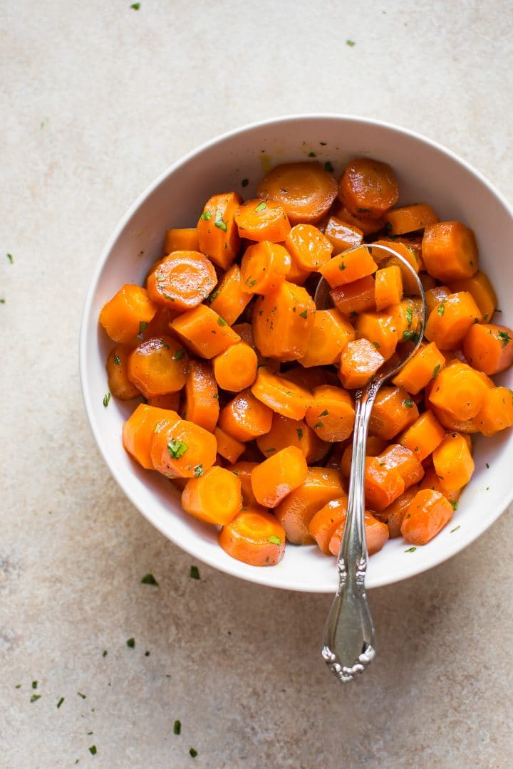 bowl of baked honey glazed carrots with a spoon