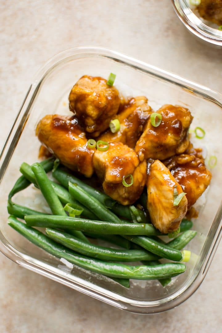 close-up of mongalian chicken, green beans, and rice in a glass container for meal prep