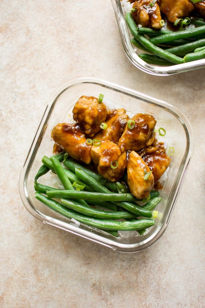 two glass meal prep containers with mongolian chicken, rice, and green beans