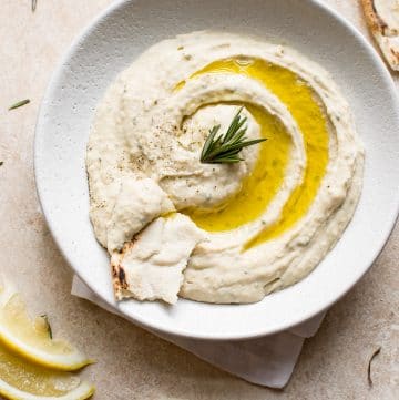 This easy vegan white bean dip is infused with rosemary, lemon juice, garlic, and good olive oil. It's a delicious and healthy dip that's perfect for girls' night or game day.
