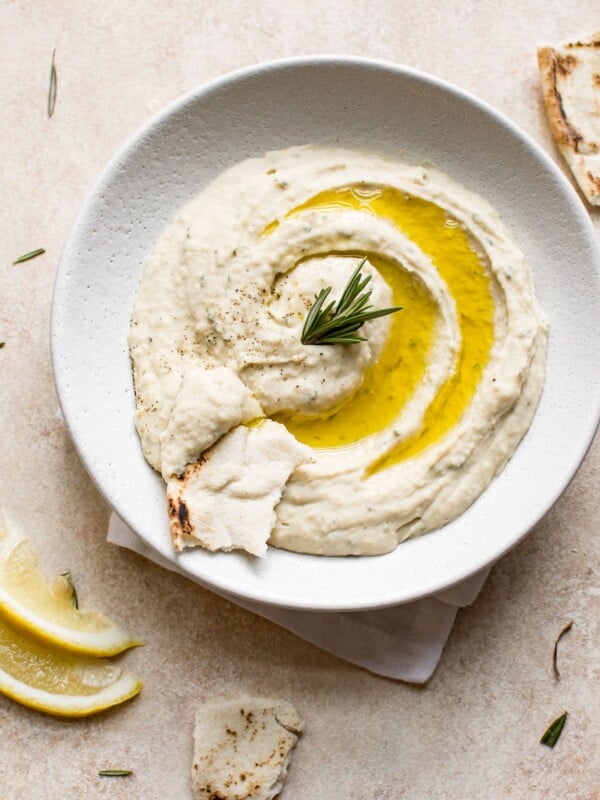 This easy vegan white bean dip is infused with rosemary, lemon juice, garlic, and good olive oil. It's a delicious and healthy dip that's perfect for girls' night or game day.