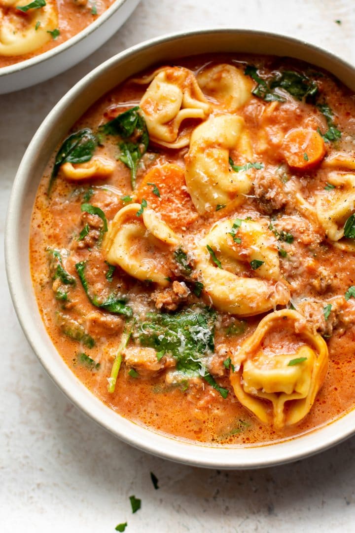 close-up of creamy slow cooker tortellini soup with sausage