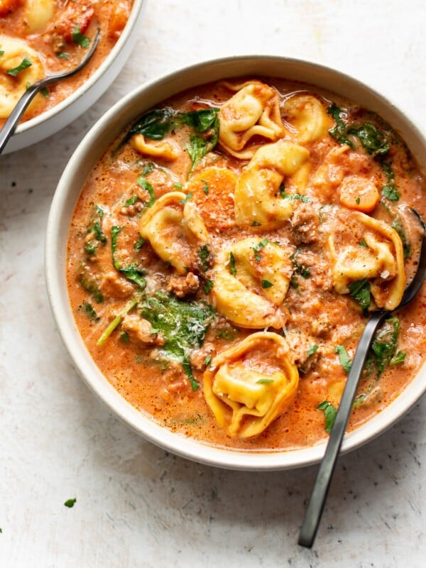 Crockpot tortellini spinach soup with sausage in two bowls